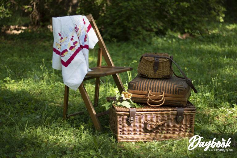 Picnic baskets in a field with a table cloth