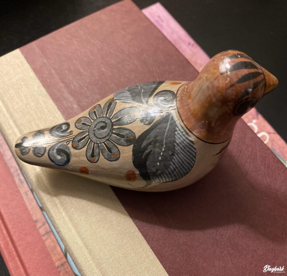 Mexican bird pottery on top of books
