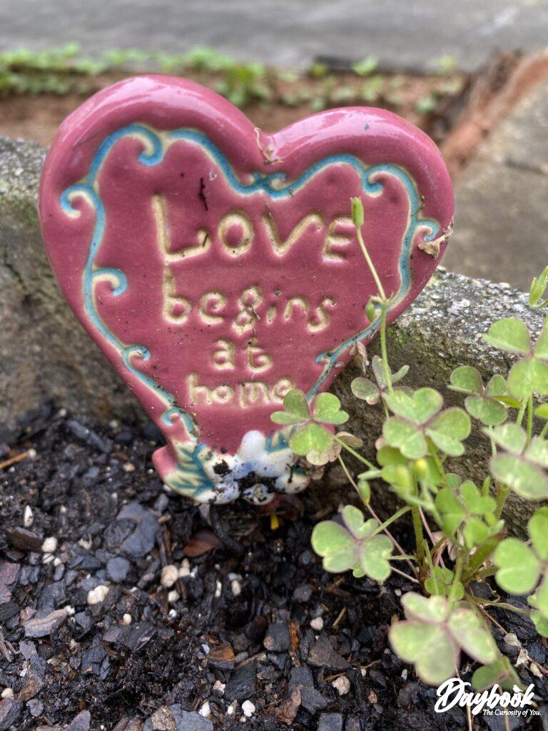 love begins at home garden sign