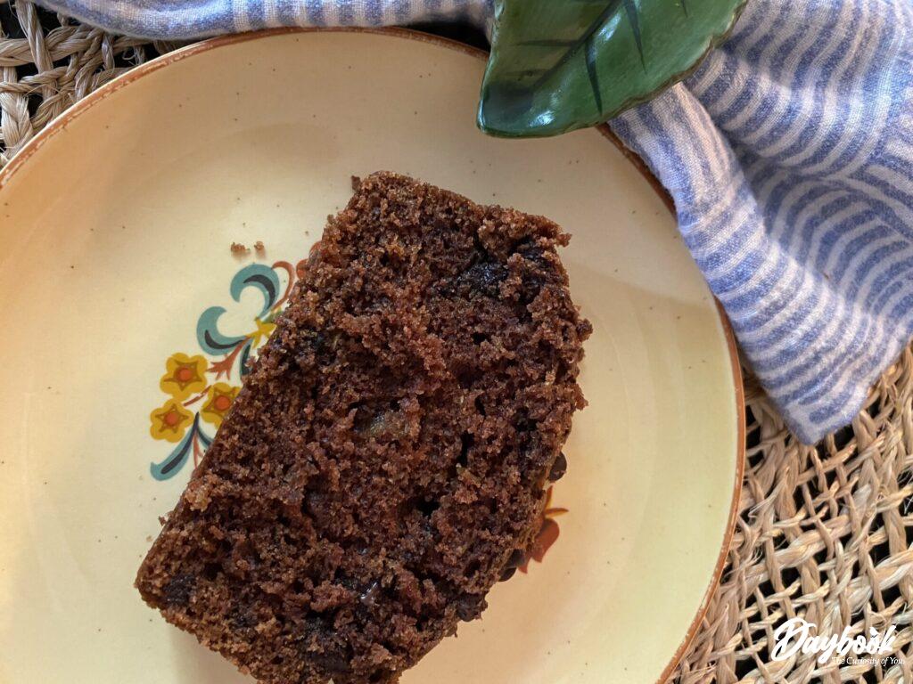 a slice of chocolate zucchini bread on a plate