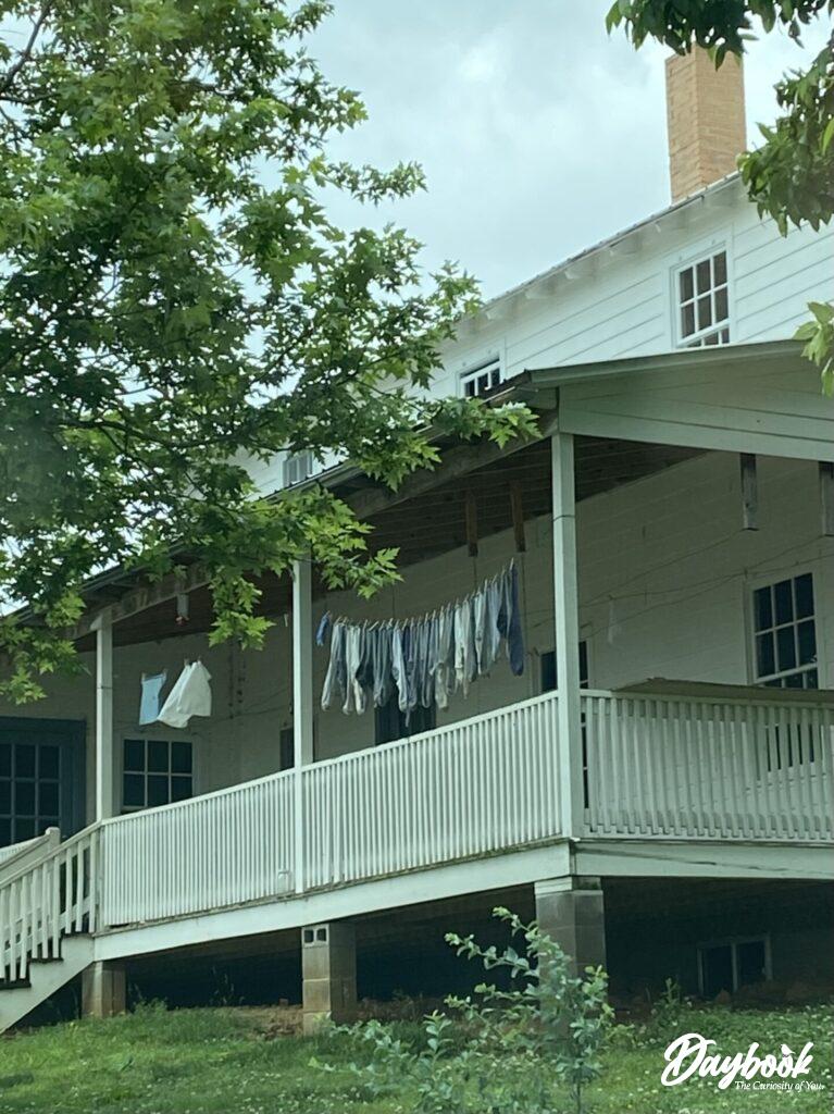 Amish porch with laundry hanging on rails