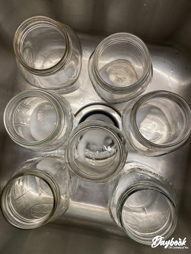 clean mason jars in a sink