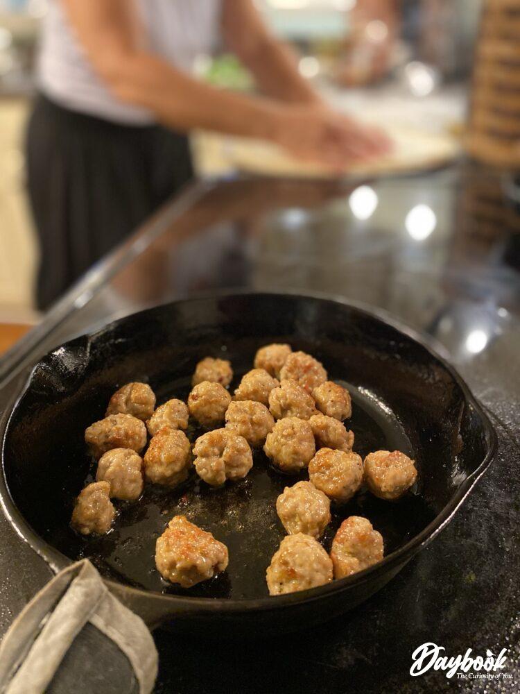 sausage balls cooking in a pan