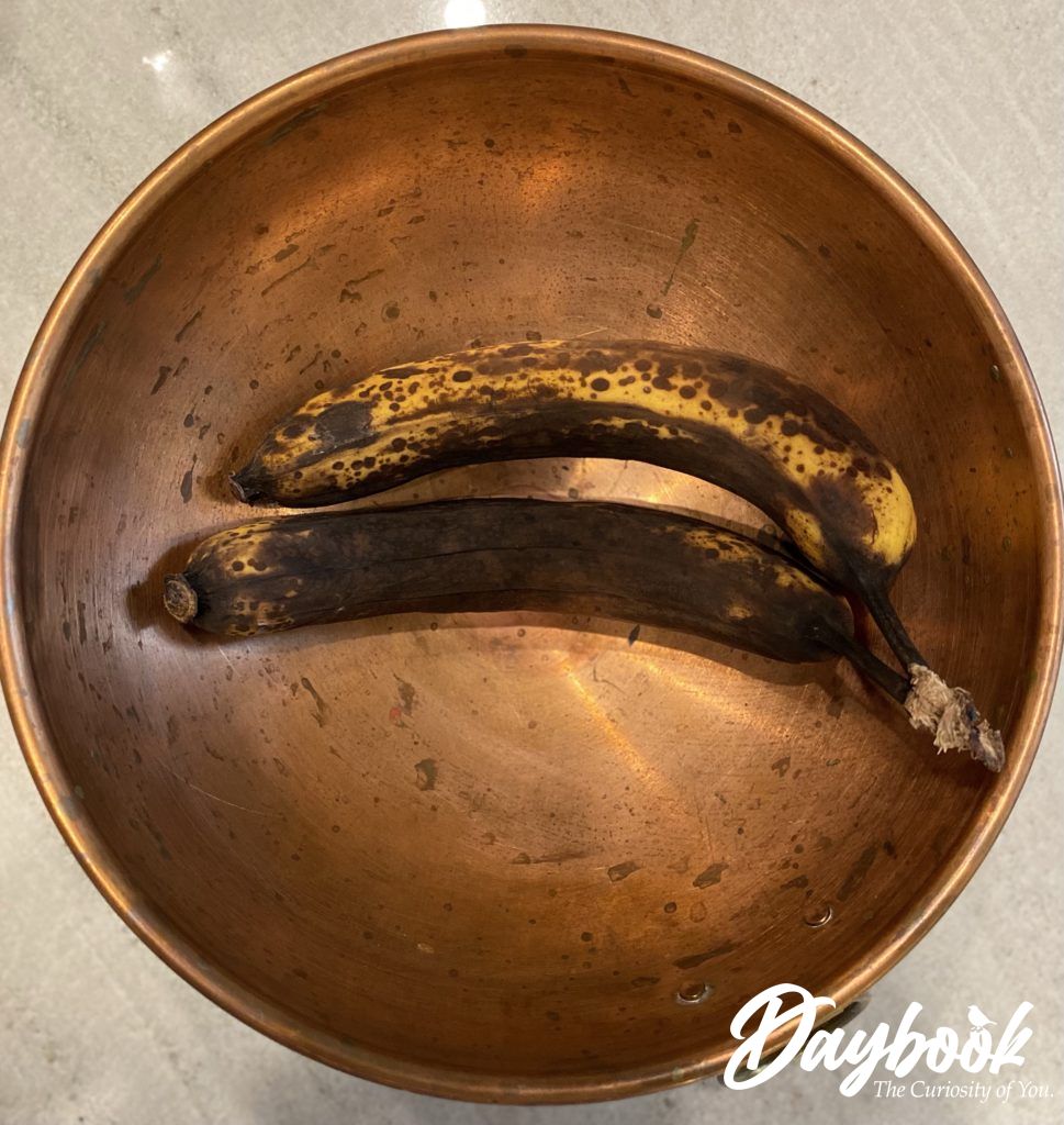 Two, too ripe bananas in a copper bowl