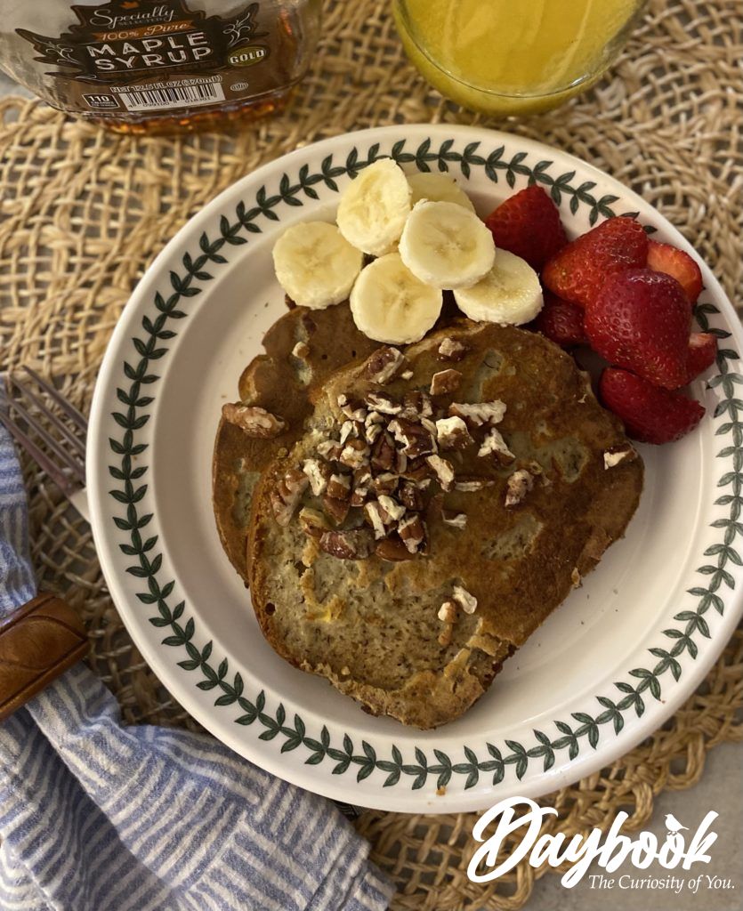 French toast made from banana bread with fruit on the side