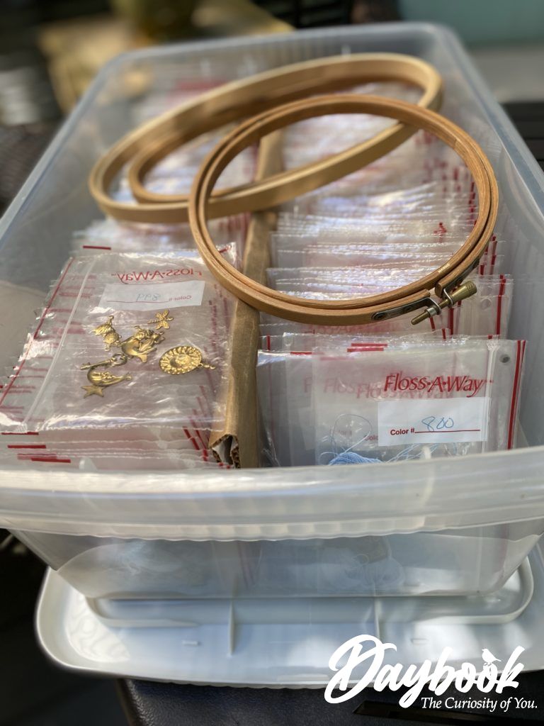 box of organized embroidery threads and wooden hoops