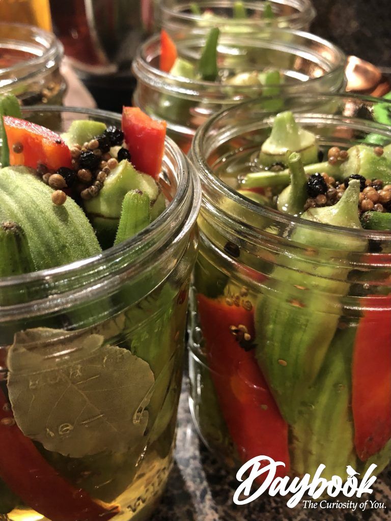 bourbon brined okra and peppers in glass jar