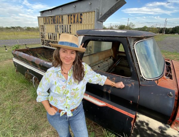 Lady in front of an old truck in Luckenbach, Texas
