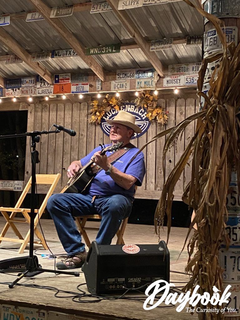 Conrad singing on the stage in Luckenbach Texas