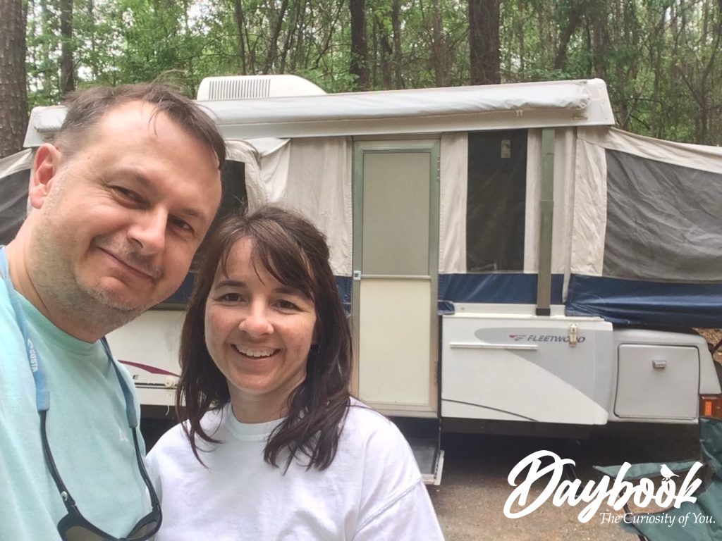 John and Kristy in front of a pop-up camper