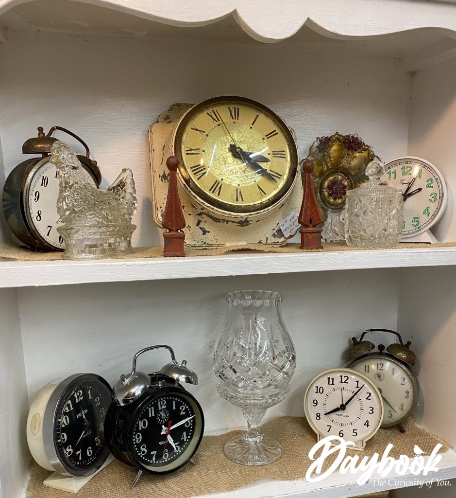 collection of antique clocks on a white shelf