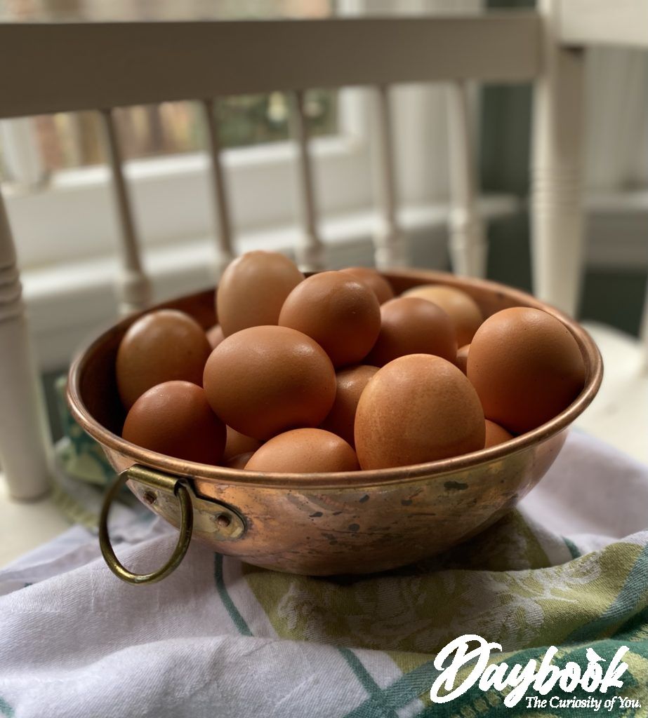 2 dozen farm fresh eggs in a copper bowl