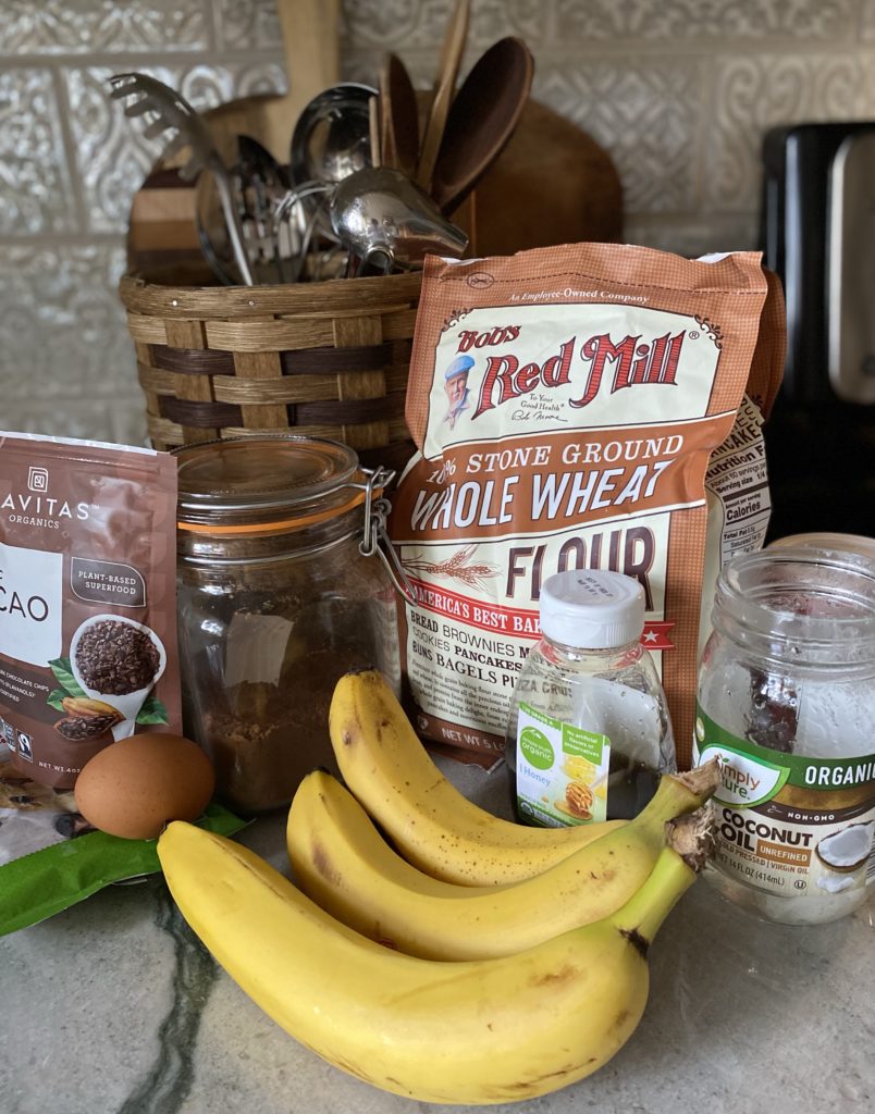 baking ingredients set out together for chocoloate banana muffins
