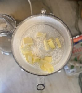 Food processor with flour sugar and cold butter