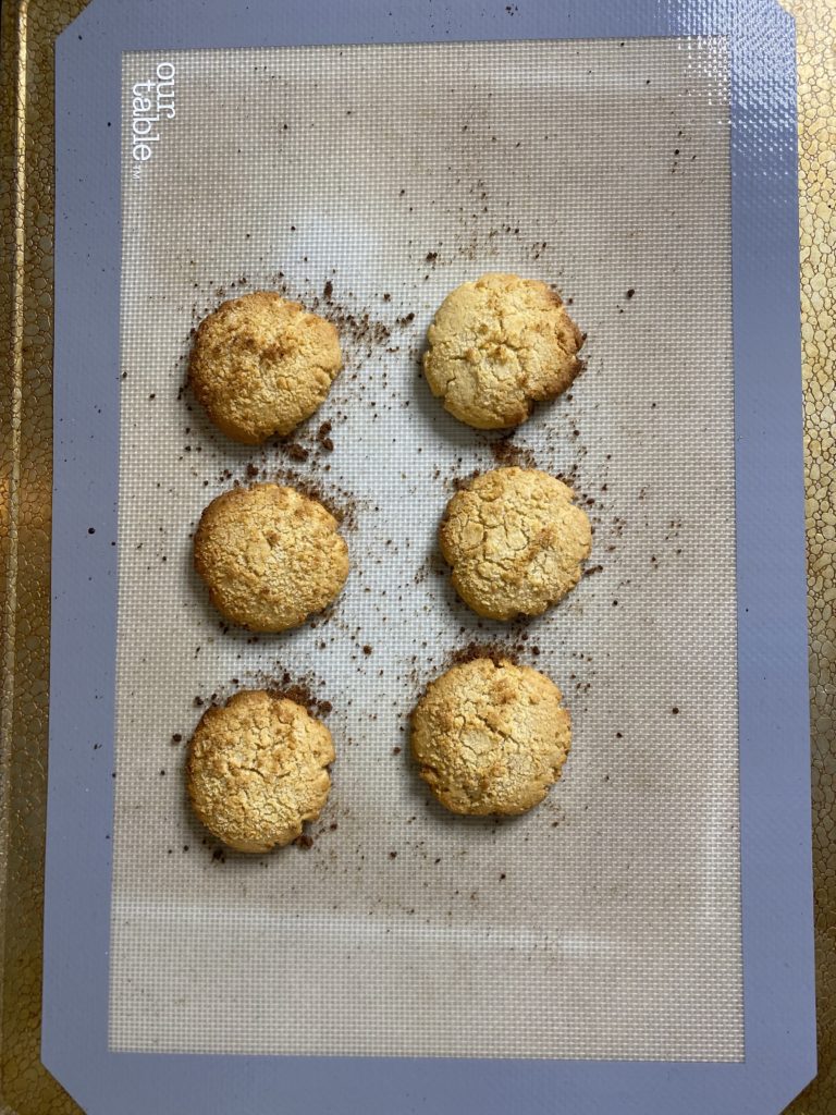 A cookie sheet with 6 baked apple crumble cookies.