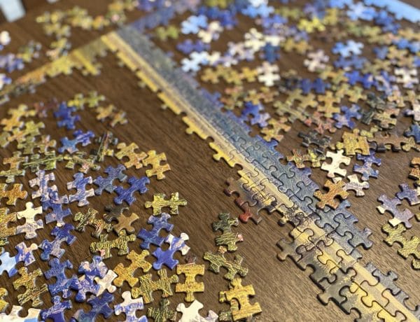 A jigsaw puzzle in progress on a dining room table