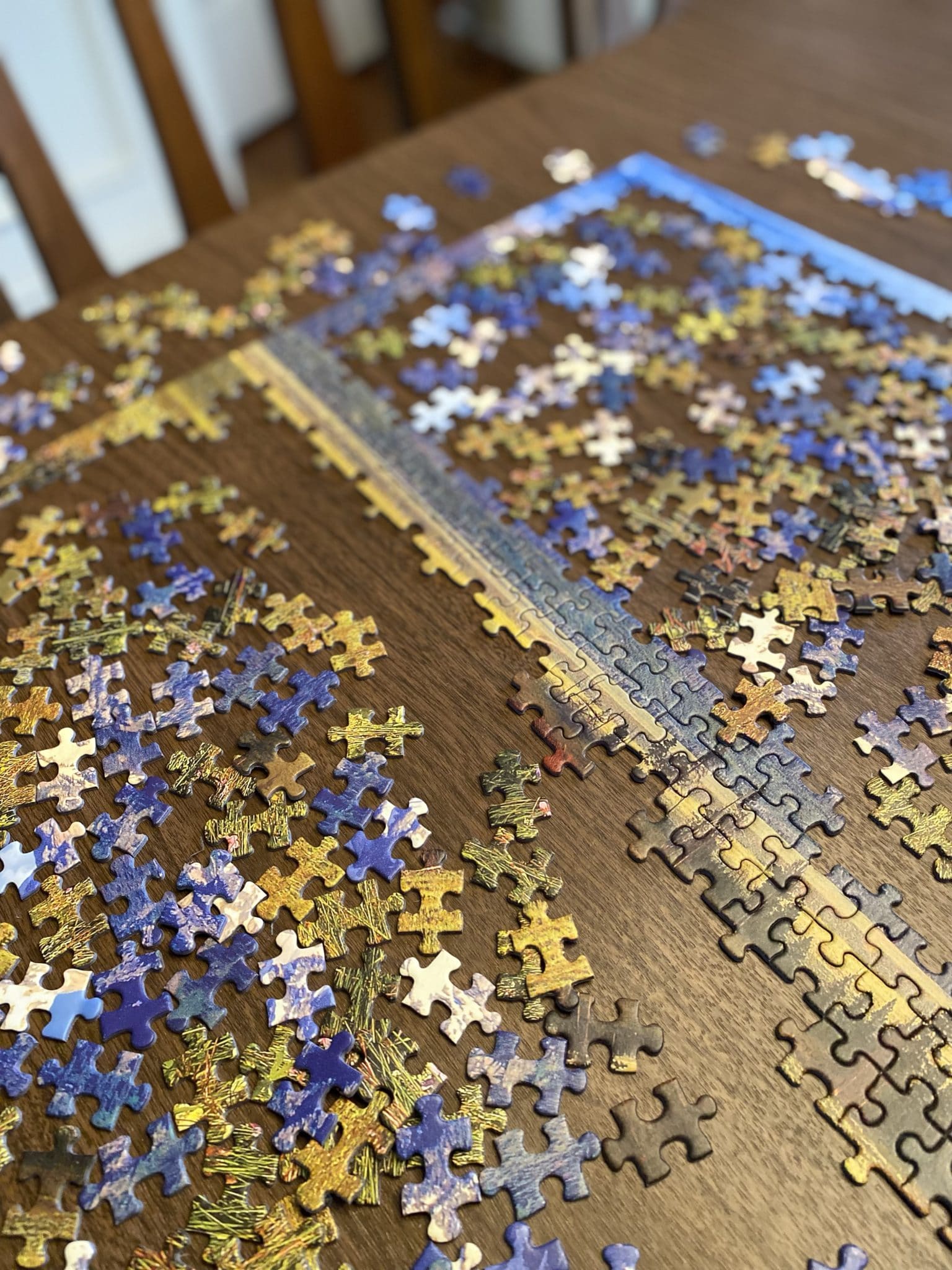 A jigsaw puzzle in progress on a dining room table