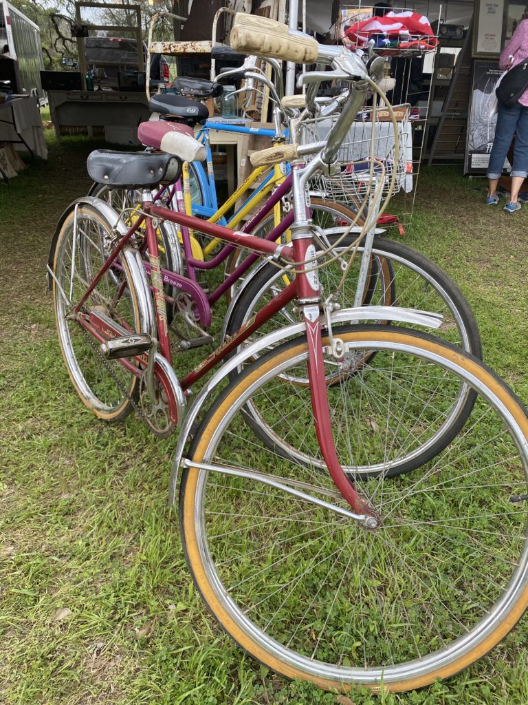 A row of vintage bicycles parked in the grass