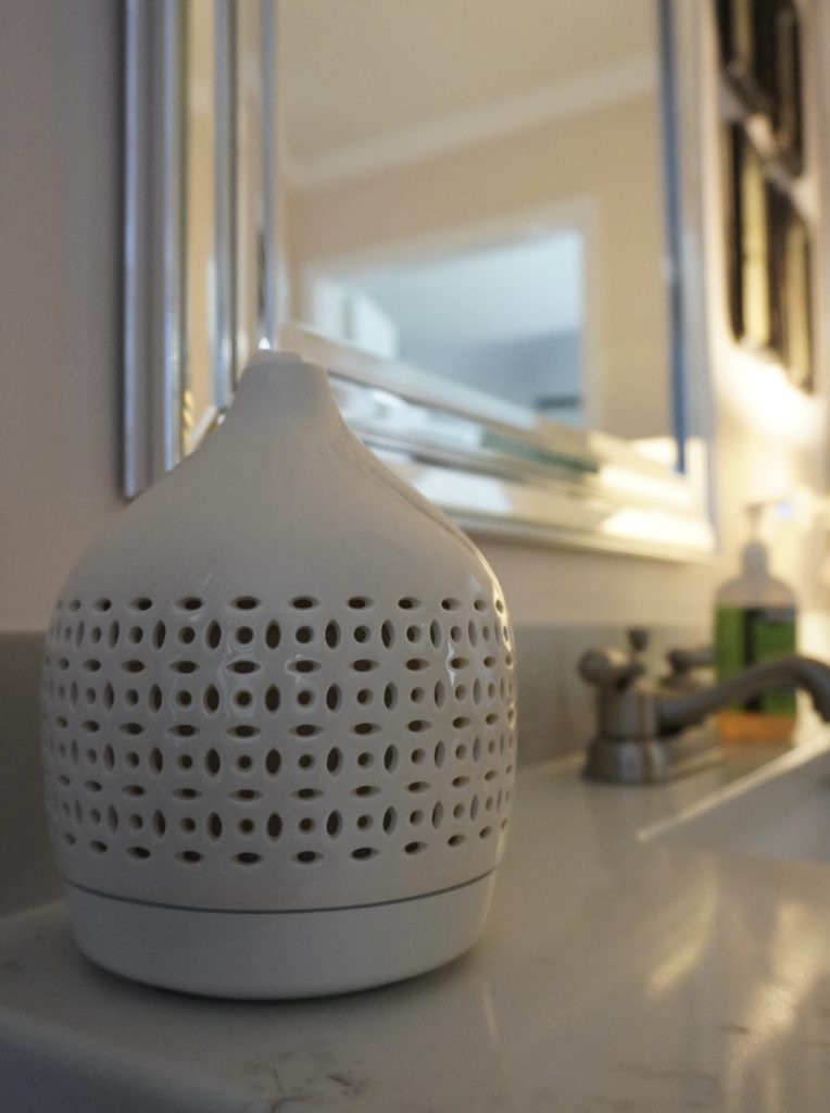 An ivory colored essential oil diffuser in a bathroom.