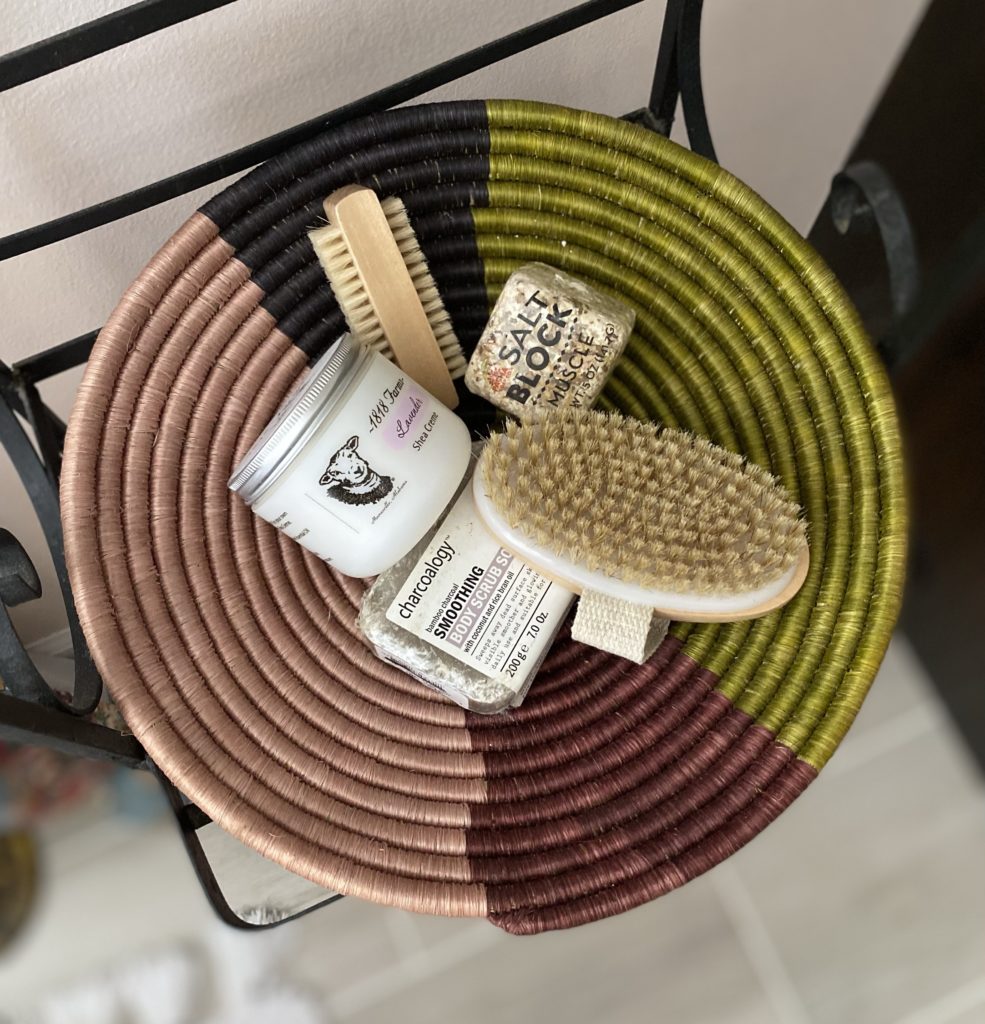 A colorful grass basket with bath accessories inside.