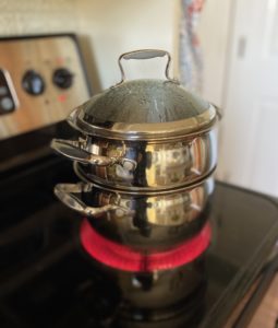 A double boiler on a hot cooktop eye.