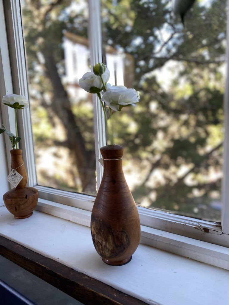 A wooden vase on a window sill in Texas.