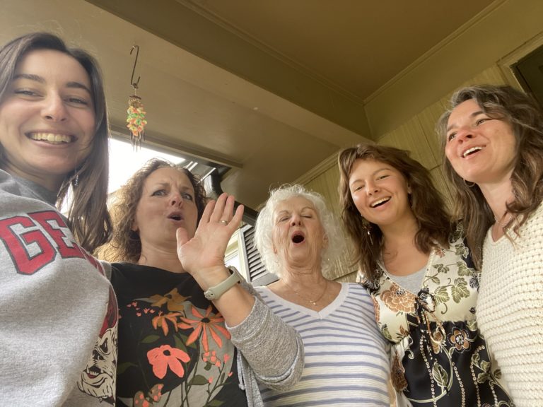 Five women caught laughing before the real picture was taken.