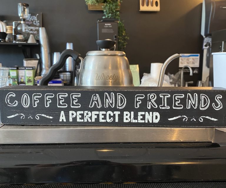 A sign in a coffee shop that reads coffee and friends...a perfect blend.