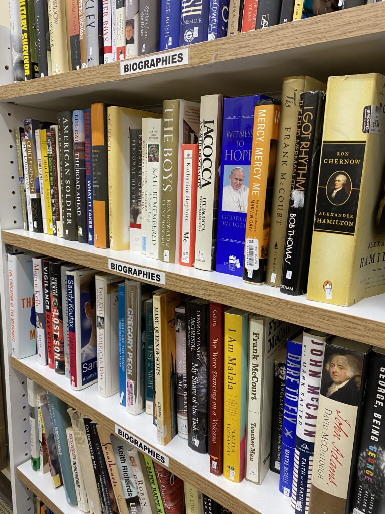 A shelf of books in a used book store.
