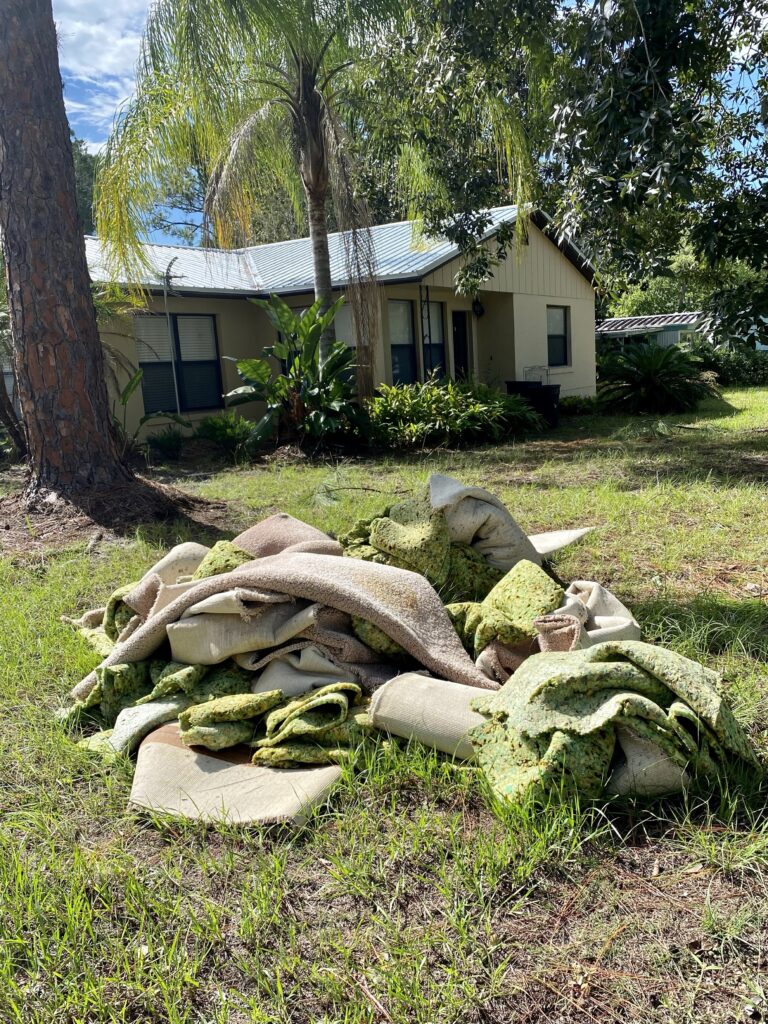 Piles of carpet that had been ripped from houses after Hurricane Idalia came through