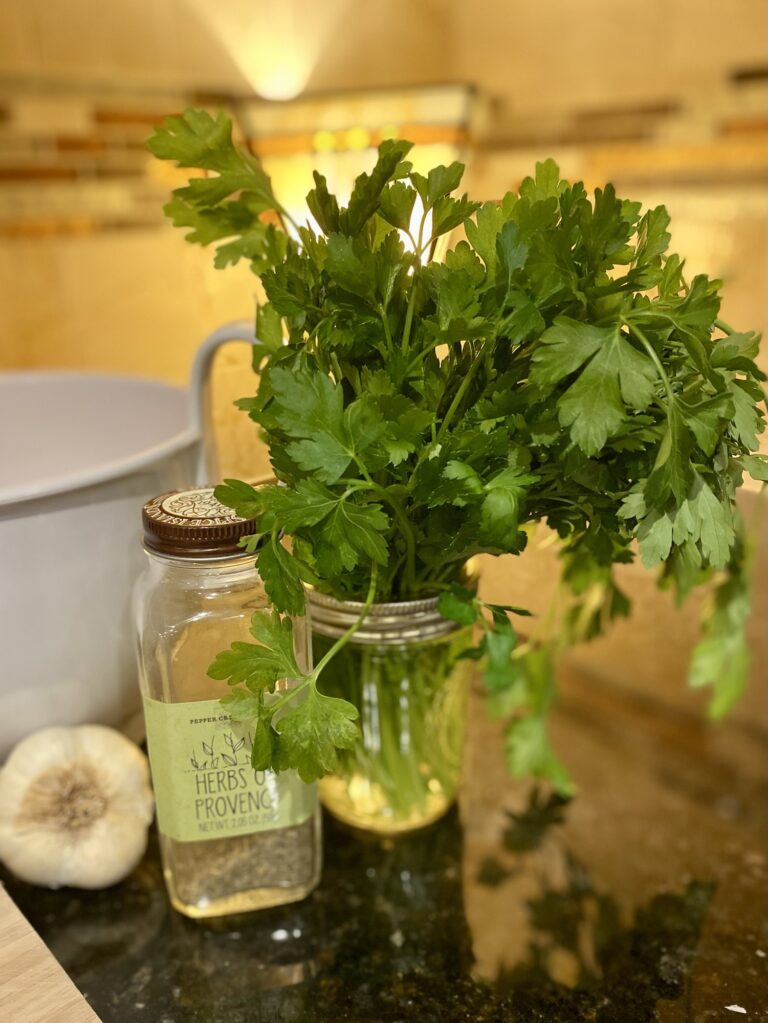 Fresh parsley and garlic on a countertop for cooking soup